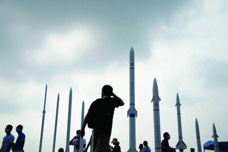 
People walk past sounding rockets displayed at the China International Aviation and Aerospace Exhibition, or Airshow China, in Zhuhai, Guangdong province, China in a file picture. 