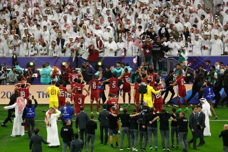Qatar's players celebrate with their supporters after winning the AFC Qatar 2023 Asian Cup final football match between Jordan and Qatar at the Lusail Stadium in Lusail, north of Doha on February 10, 2024. (Photo by KARIM JAAFAR / AFP)
