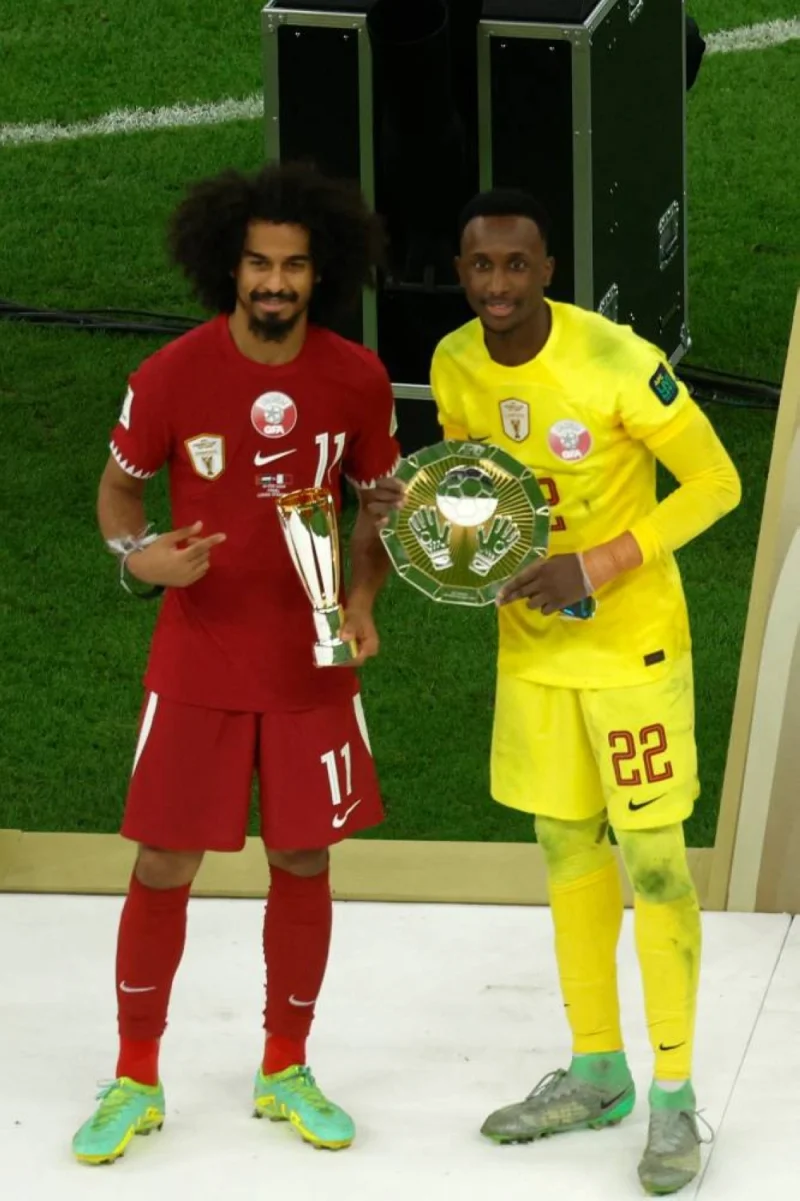 Qatar&#039;s forward #11 Akram Afif holds his Most Valuable Player Award trophy alongside his goalkeeper #22 Meshaal Barsham with the latter&#039;s Top Goal Scorer Award trophy during the podium ceremony after the AFC Qatar 2023 Asian Cup final football match between Jordan and Qatar at the Lusail Stadium in Lusail.