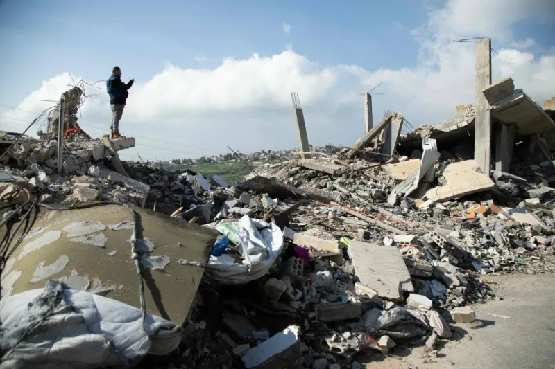 A man inspects the damage due to Israeli strikes on the southern Lebanese village of Houla near the border on Sunday 