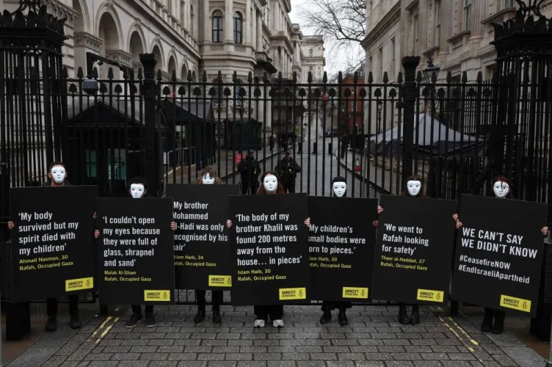 Activists from Amnesty International hold placards with statements made by civilians living in Rafah, in Gaza, during a silent vigil outside the gates of Downing Steet in central London, on Wednesday, as they call "on the UK government to use all the means at its disposal to press the Israeli authorities into reversing any decision to launch a full-scale attack on Rafah". AFP