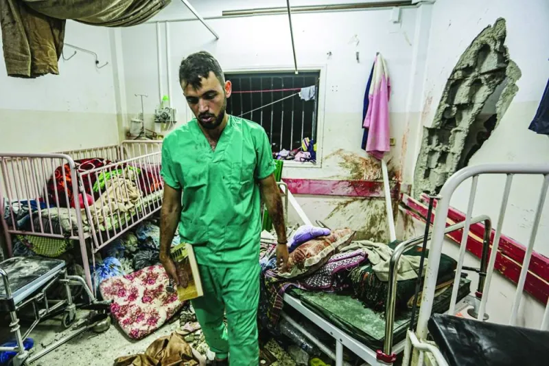 File photo shows a man inspect the damage in a room following Israeli bombardment at Nasser hospital in Khan Younis in the southern Gaza Strip on December 17, 2023, amid the ongoing conflict.