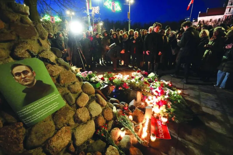 A memorial for Alexei Navalny is seen as people demonstrate and pay their respect following his death in prison, at the monument for victims of political repressions in Vilnius.