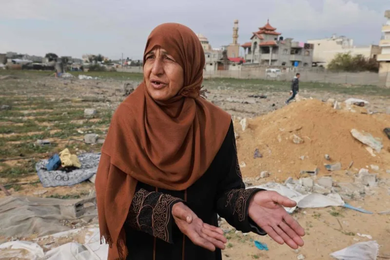 A Palestinian woman reacts as she inspects the destruction in Rafah on Sunday. AFP