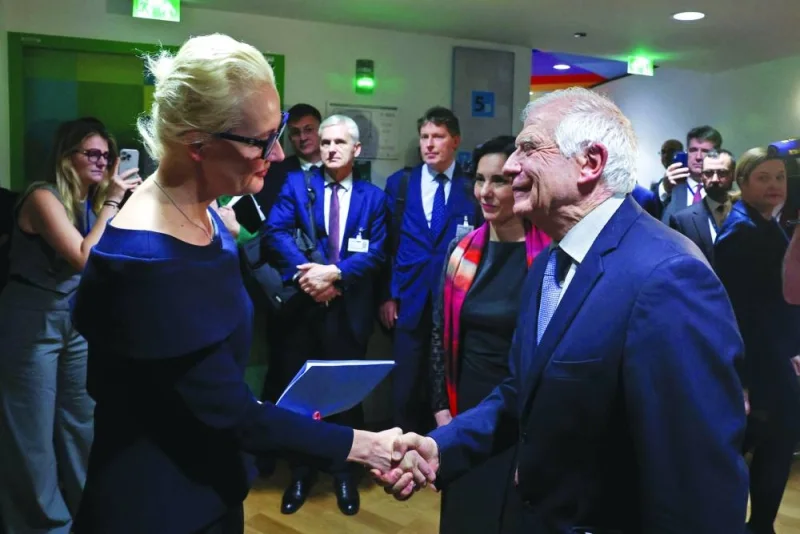 Leading Kremlin critic  Alexei Navalny’s widow Yulia Navalnaya shakes hands with European Union Foreign Policy Chief Josep Borrell before a meeting of EU Foreign Ministers in Brussels on Monday. (AFP)