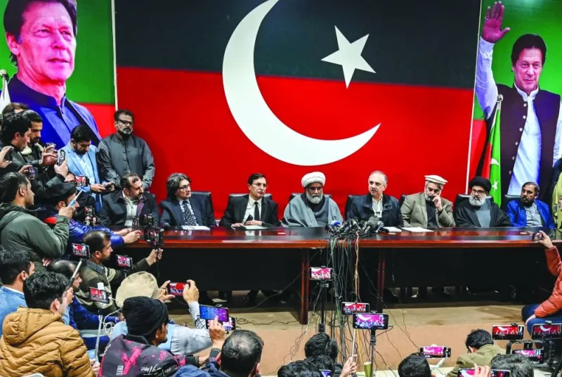 Omar Ayub Khan (fourth right), Pakistan Tehreek-e-Insaf’s nominee for prime minister speaks as Gohar Ali Khan (third left seated), PTI’s chairman and barrister, with Sahibzada Mohamed Hamid Raza (third right), leader of the political group Sunni Ittehad Council, watch during a news conference in Islamabad on Monday. (AFP)
