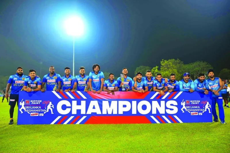 Sri Lankan players pose with the series trophy after their victory at the third and final T20I against Afghanistan in Dambulla on Wednesday. (AFP)