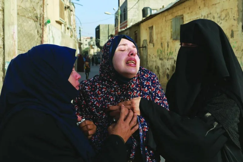 Rania Abu Anza (centre) the mother of twin babies Naeem and Wesam, killed in an overnight Israeli air strike, mourns their death ahead of their burial in Rafah in the southern Gaza Strip, on Sunday.