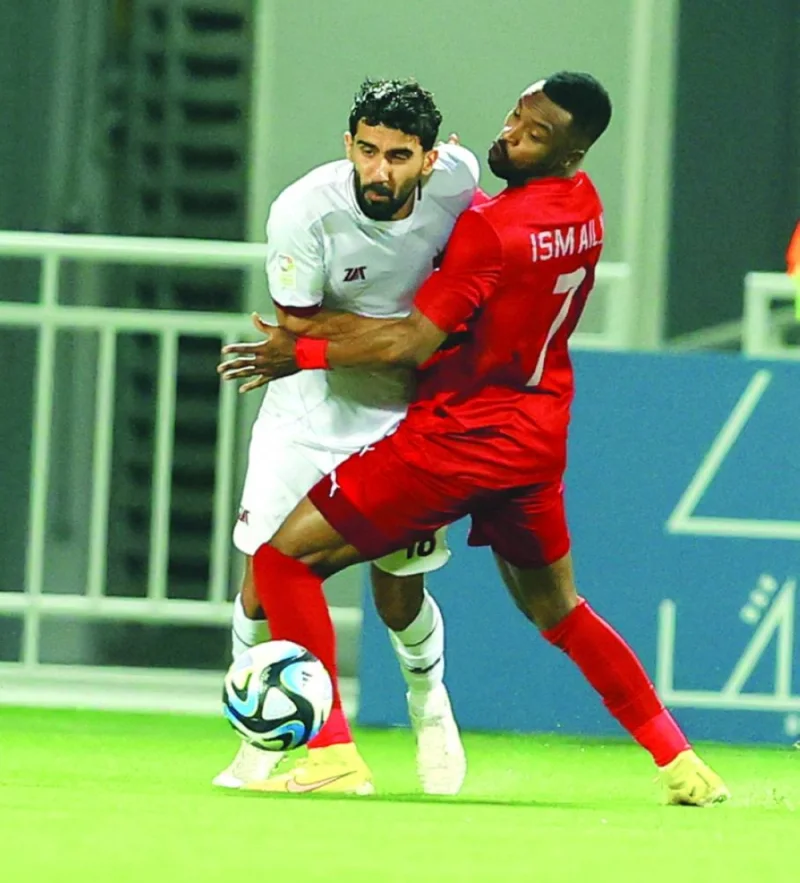 Al Duhail’s Ismail Mohamed (right) and Al Markhiya’s Bashar Rasan vie for the ball during the Expo Stars League match on Tuesday.