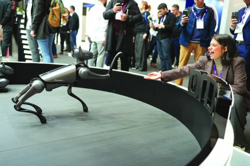 INTERACTION: An attendee banters with a prototype robot at the MWC24 in Barcelona. (GSMA photo)