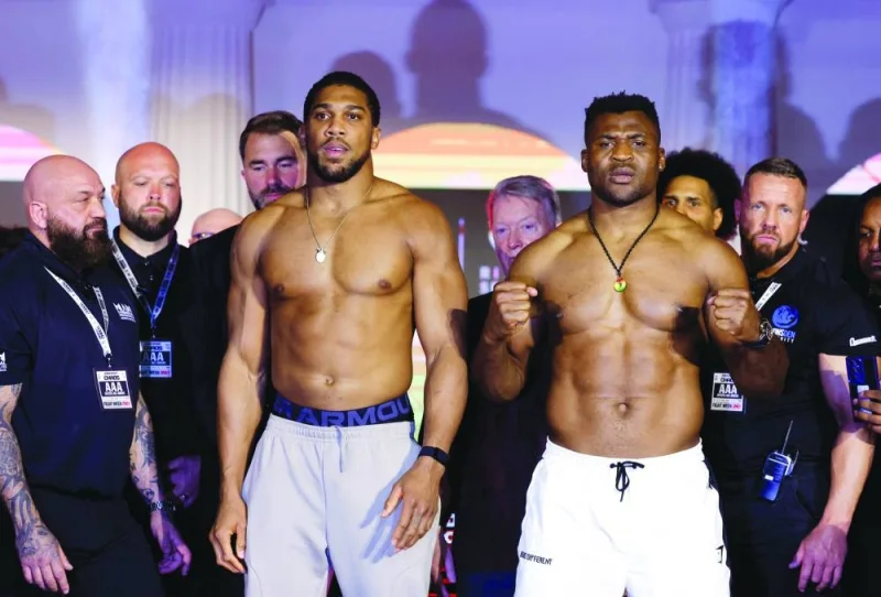 Antony Joshua (left) and Francis Ngannou pose during the weigh-in at BLVD World, Riyadh, Saudi Arabia, on Thursday. (Reuters)