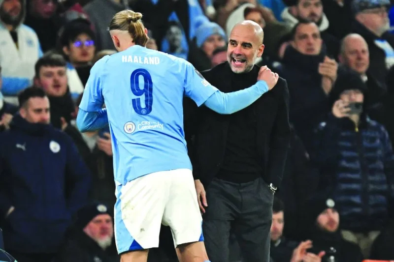
Manchester City’s Spanish manager Pep Guardiola congratulates Erling Haaland as he leaves, substituted during the Champions League round of 16, second-leg, match against FC Copenhagen in Manchester. (AFP) 