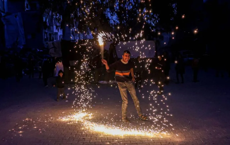 A Palestinian child plays with a sparkler in Rafah, on the eve of the Muslim holy fasting month of Ramadan Sunday.