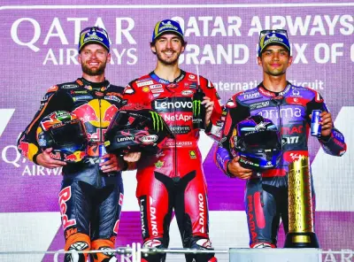 First placed Italian MotoGP rider Francesco Bagnaia of Ducati Lenovo Team, second placed South African MotoGP rider Brad Binder of Red Bull KTM Factory Racing and third placed Spanish MotoGP rider Jorge Martin of Prima Pramac Racing celebrate on the podium after the MotoGP race of the Motorcycling Grand Prix of Qatar at the Losail International Circuit in Doha yesterday. PICTURES: Noushad Thekkayil