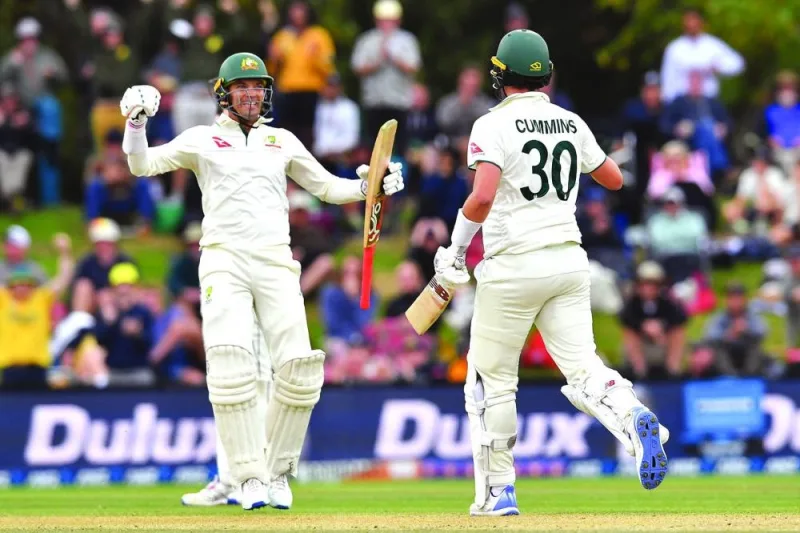 Australia’s Pat Cummins (right) and Alex Carey celebrate their victory on day four of the second Test against New Zealand at Hagley Oval in Christchurch on Monday. (AFP)