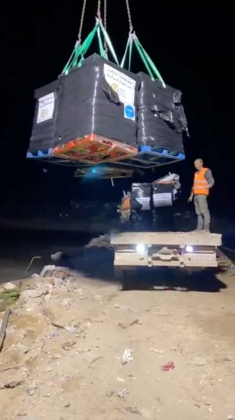 Workers unload aid packages from a ship arriving from Cyprus at the Gaza coast, on Saturday, in this screengrab obtained from social media video. World Central Kitchen/Handout via REUTERS