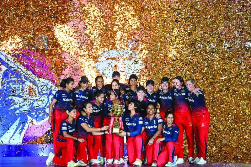 Royal Challengers Bangalore&#039;s players hold the trophy after winning the Women&#039;s Premier League (WPL) Twenty20 cricket final match against Delhi Capitals in New Delhi yesterday. (AFP)