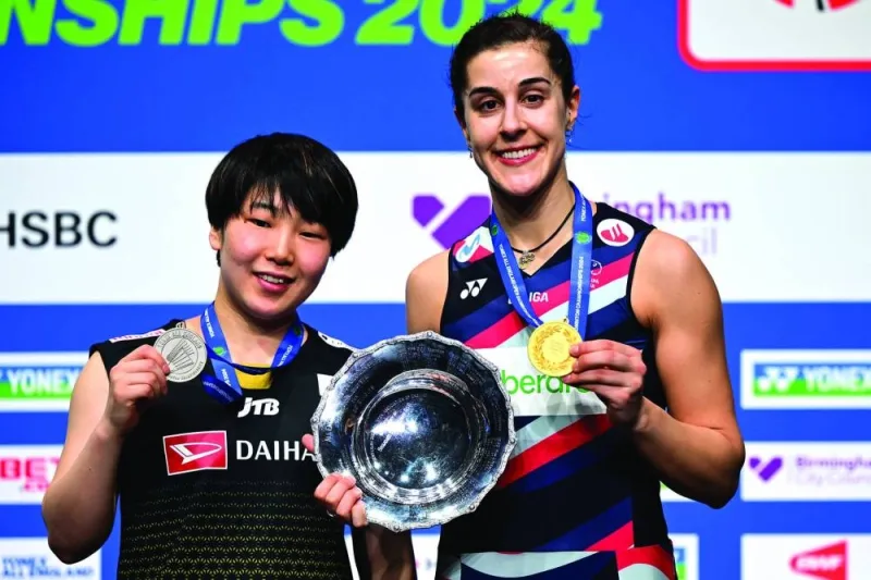 Japan&#039;s Akane Yamaguchi (left) and winner Spain&#039;s Carolina Marin are seen on the podium after competing in the women&#039;s singles final at the All England Open Badminton Championships at the Utilita Arena in Birmingham, central England, yesterday. (AFP)