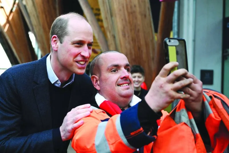Britain’s Prince William, Prince of Wales, poses for pictures with a member of the public as he is on his way to attend a Homewards Sheffield Local Coalition meeting at the Millennium Gallery in Sheffield, northern England yesterday. Homewards is a transformative five-year programme which plans to demonstrate that by working collaboratively across all areas of society, it will be possible to end homelessness in the UK.