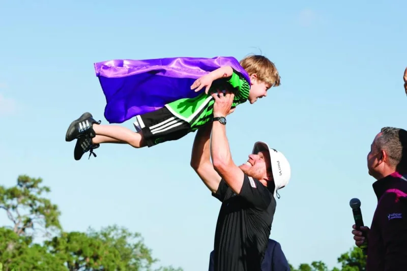 
Peter Malnati tosses his son Hatcher into the air after winning the Valspar Championship golf tournament. (USA TODAY Sports) 