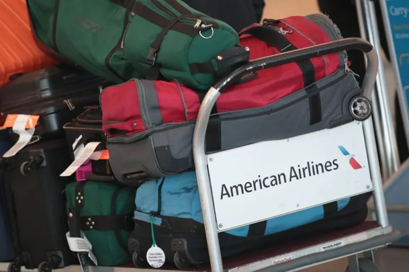 Luggage is prepared for an American Airlines flight at O&#039;Hare International Airport in Chicago. As demand for air travel rebounds to pre-pandemic levels, the cost of flights is soaring, compounded by escalating expenses such as baggage fees. These surging fees are reportedly placing a considerable strain on travellers&#039; finances.