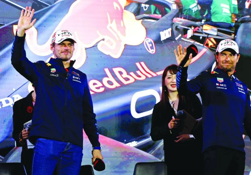 Red Bull’s Formula One drivers Max Verstappen (left) and Sergio Perez attend a promotional event ahead of Japanese Grand Prix in Tokyo on Wednesday. (Reuters)