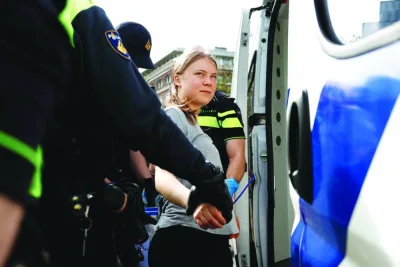 
Swedish climate campaigner Greta Thunberg is detained by police in The Hague yesterday. (Reuters) 