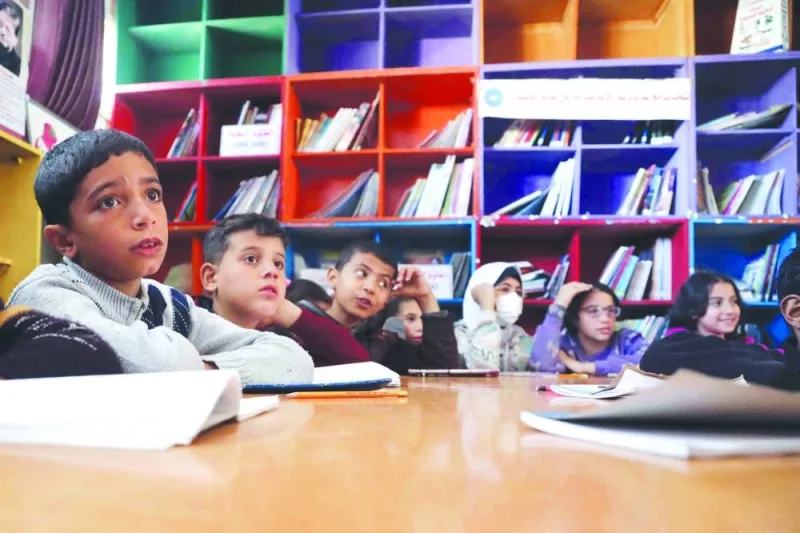 Displaced Palestinian children attend an English class in the library of the school housing displaced Gazans, in Rafah in the southern Gaza Strip.Fsi