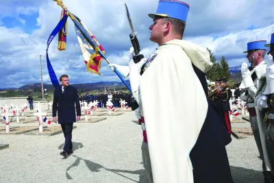 Macron reviews troops during a tribute ceremony for the Vercors 
resistance fighters and civilian victims in Vassieux-en-Vercors, France.