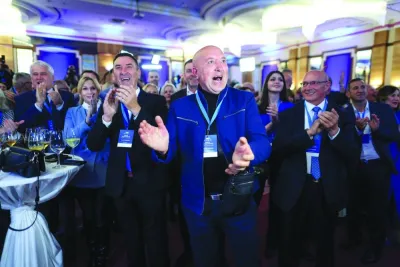 Supporters of Croatian Democratic Union (HDZ) party react to the preliminary results of the parliamentary election, in Zagreb, on Wednesday.