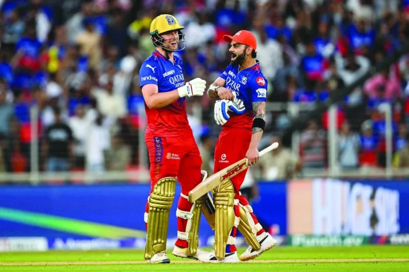 Royal Challengers Bengaluru’s Virat Kohli and Will Jacks (left) celebrate their team’s win in the Indian Premier League match against Gujarat Titans in Ahmedabad yesterday. (AFP)
