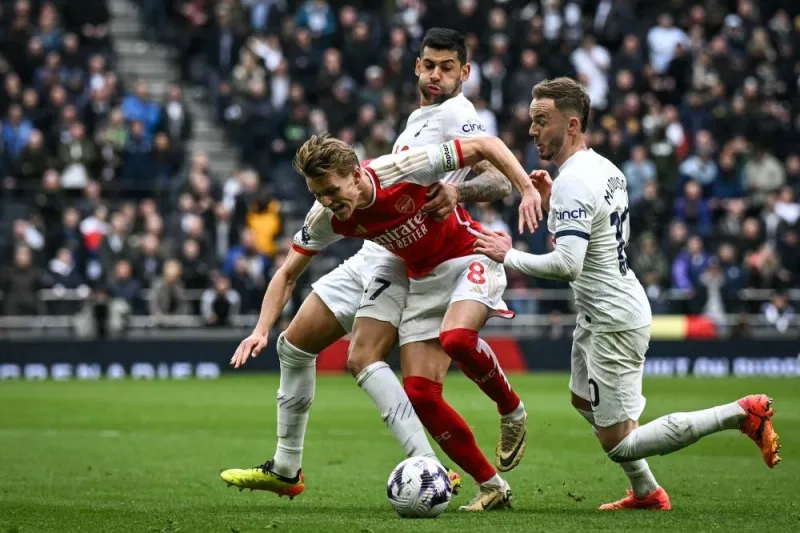 Tottenham Hotspur&#039;s defender Cristian Romero, James Maddison and Arsenal&#039;s midfielder Martin Odegaard vying for the ball during the Premier League match in London yesterday. (AFP) 