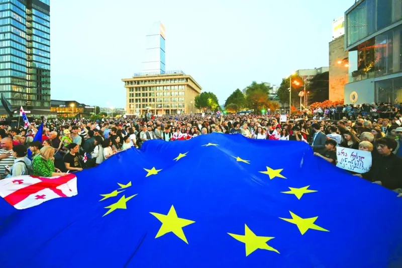 
Demonstrators hold a giant EU flag during their protest against a controversial ‘foreign influence’ bill, which Brussels warns would undermine Georgia’s European aspirations, in Tbilisi. 
