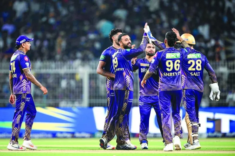 Kolkata Knight Riders’ Varun Chakravarthy (left) celebrates with teammates after taking the wicket of Delhi Capitals’ Kumar Kushagra (not pictured) on Monday. (AFP)