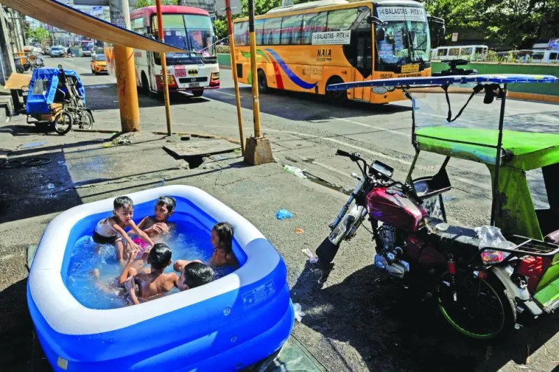 
Children swim in an inflatable pool during a hot day in Manila. 