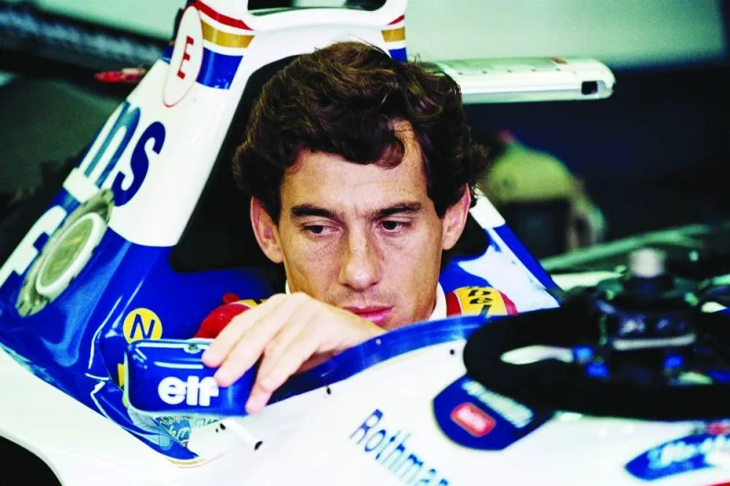 
Brazilian F1 driver Ayrton Senna adjusts his rear view mirror in the pits before the start of the San Marino Grand Prix on May 1, 1994. Senna died after crashing in the seventh lap. (AFP) 