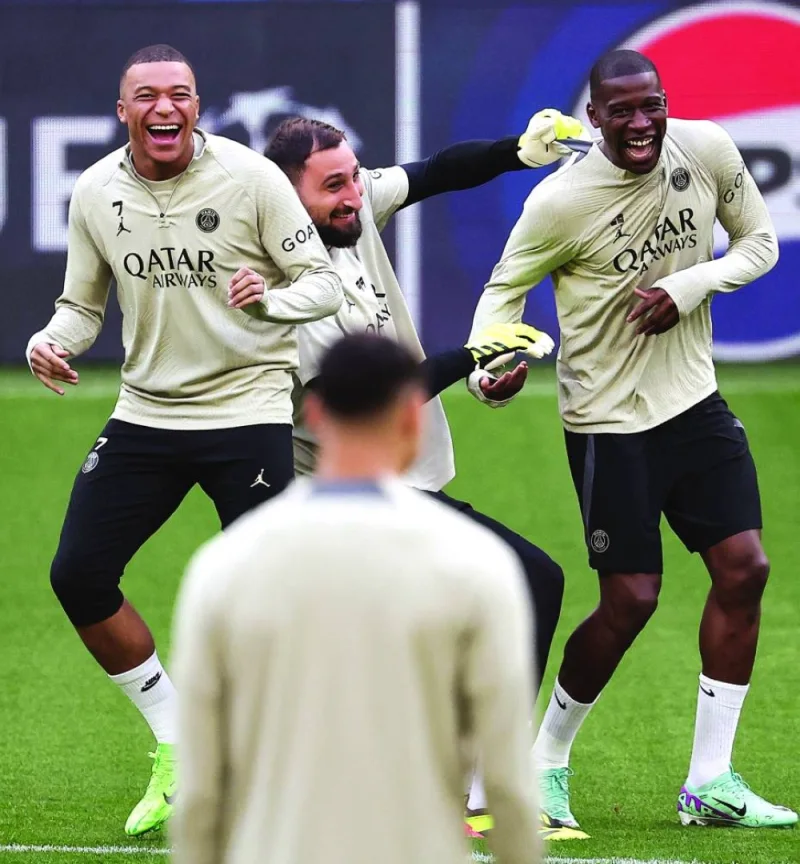 
Paris Saint-Germain’s Gianluigi Donnarumma (centre) jokes with teammates Nordi Mukele (right) and Kylian Mbappe during a training session in Dortmund, western Germany. (AFP) 