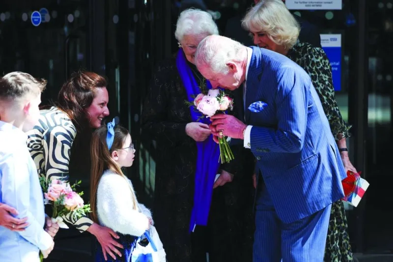 
Charles is seen after receiving flowers from a young patient during his visit to the University College Hospital Macmillan Cancre Centre in London. 