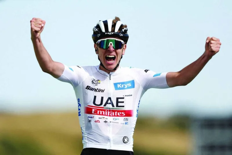 
UAE Team Emirates’ Tadej Pogacar celebrates as he crosses the finish line to win stage 20 of the Tour de France on July 22, 2023. (Reuters) 