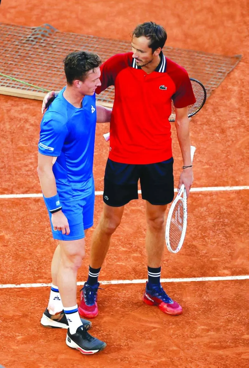 Russia’s Daniil Medvedev (right) with Czech Republic’s Jiri Lehecka after retiring from the quarter-final match in Madrid on Thursday. (Reuters)