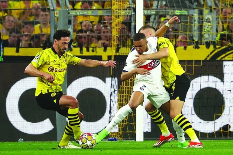 
Paris Saint-Germain’s Kylian Mbappe (centre) vies for the ball with Borussia Dortmund’s Mats Hummels (left) and Nico Schlotterbeck during the UEFA Champions League semi-final first leg match in Dortmund, Germany, on Wednesday. (AFP) 