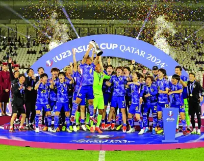 Japan players celebrate with the trophy after winning the AFC U23 Asian Cup Stadium in Doha on Friday.