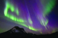 
This picture shows northern lights (Aurora Borealis) over the mountain at Utakleiv, in Norway’s Lofoten Islands. 