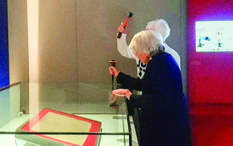 
This picture taken on Friday shows Parfitt and Bruce breaking parts of the reinforced case holding an original text of the Magna Carta in the British Library in London. 