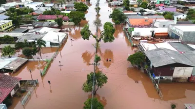 A drone view shows people walking on a flooded street in Eldorado do Sul, Rio Grande do Sul state, Brazil.