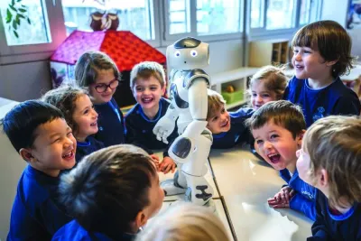 Preschoolers interact with educational and interactive robot Nao at "La Nanosphere" creche in the university campus of the Swiss Federal Institute of Technology in Lausanne, western Switzerland, last February. (AFP)