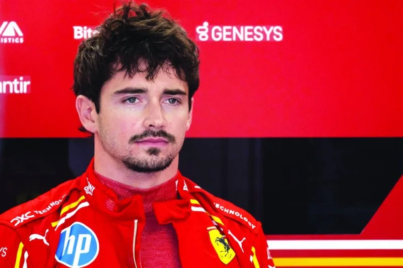 Ferrari&#039;s Monegasque driver Charles Leclerc prepares in the garage for the first practice session in Imola, Italy, on Friday. (AFP)