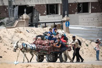 Palestinians transporting their belongings on a donkey-pulled cart arrive in Khan Yunis  in the southern Gaza Strip to seek shelter , on Saturday. AFP