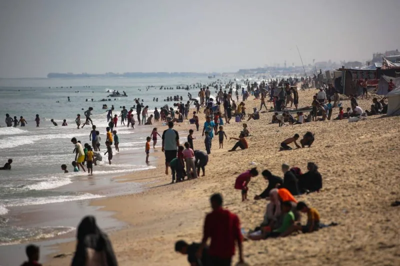 Displaced Palestinians swim next to a temporary camp in Rafah on Friday. AFP