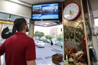 An Iranian man watches the news on TV in a restaurant in Tehran as state TV reported that a helicopter carrying Iran&#039;s president was involved in "an accident" in poor weather conditions on his way back from the province of East Azerbaijan where he inaugurated a dam project together with his Azeri counterpart on Sunday. AFP